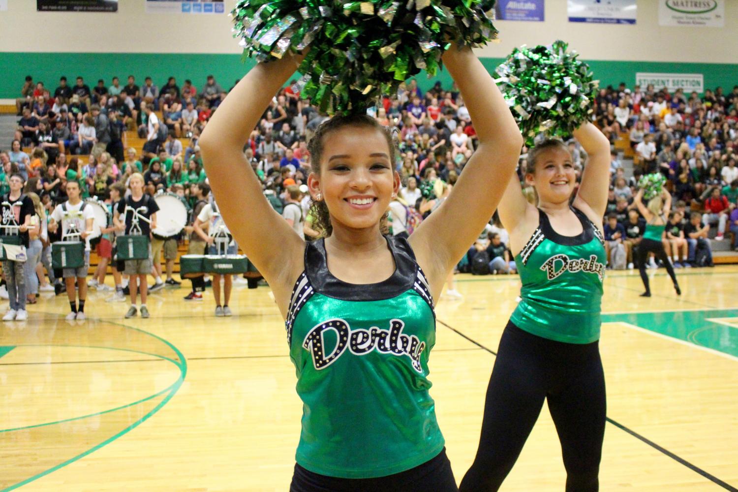 Seniors Sydney Bradley and Ryenne Bishop smile as they dance in front of the student body. Bradley has been on the Pantherettes for four years. "It's very entertaining," Bradley said. "Especially at games when we're all hyped up and ready to win".