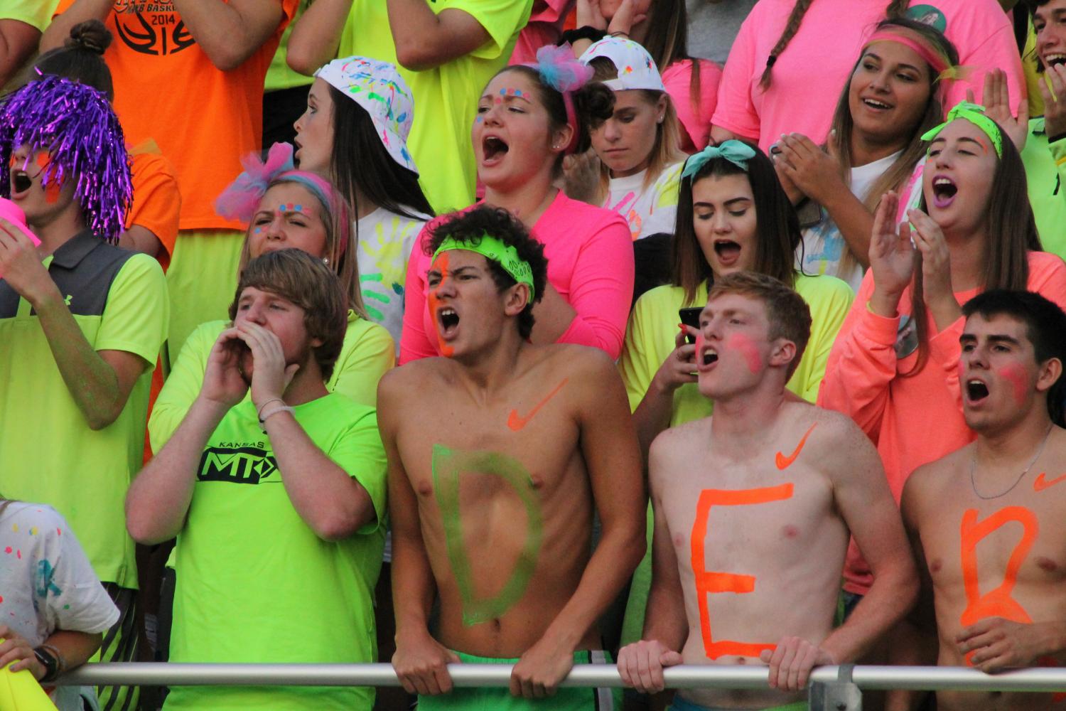 The+student+section+gets+lit+with+neon+night.+