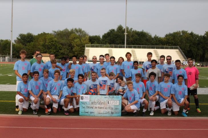 The team poses with the check presented for their fundraiser. 