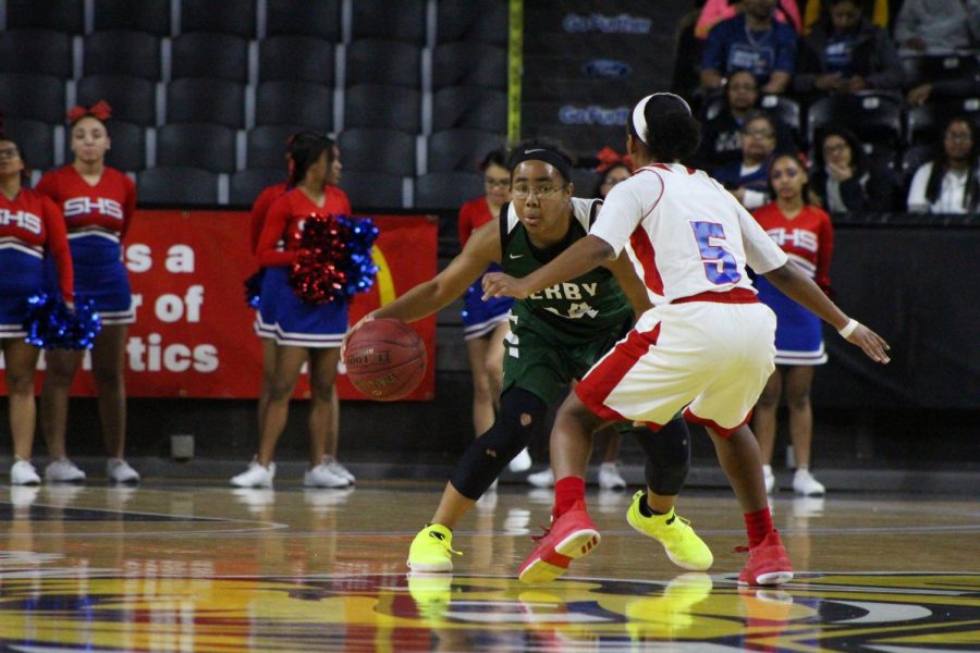 Junior Tore Alford switches up her dribble, tricking her opponent.