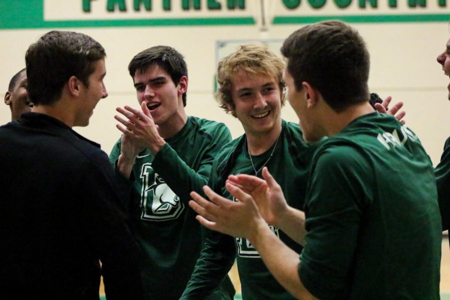The boys basketball team laughs during their pregame warmup.