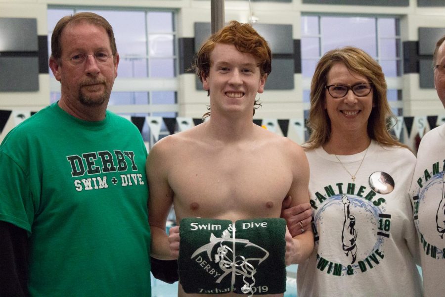 Senior Zachary Fitzwater poses with his parents on senior night, hosted at the Campus natatorium. 