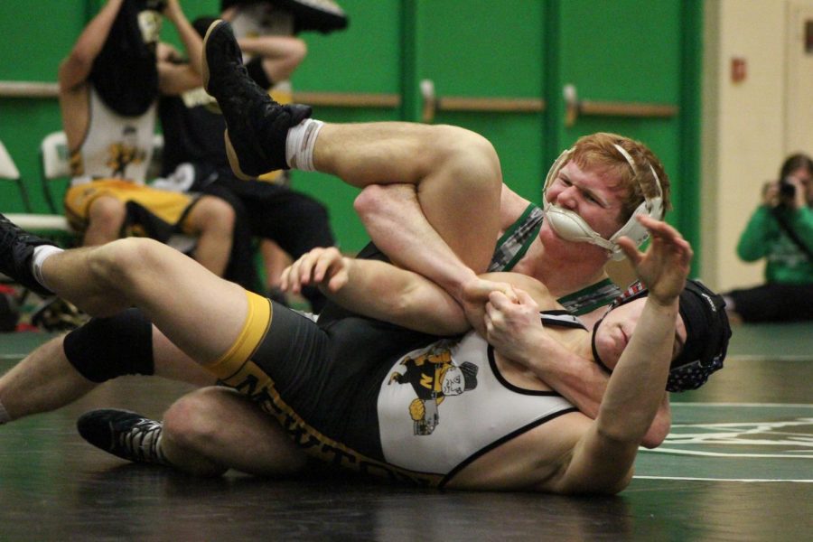 Sophomore Jace Jenkins holds down his opponent for a pin. Jenkins was the start of a four pin streak that gave the Panthers the lead against Newton.