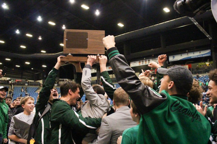The+Derby+Wrestling+team+and+its+coaches+raise+the+class+6A+state+championship+trophy.+The+last+time+Derby+Wrestling+won+a+state+title+was+in+1986.