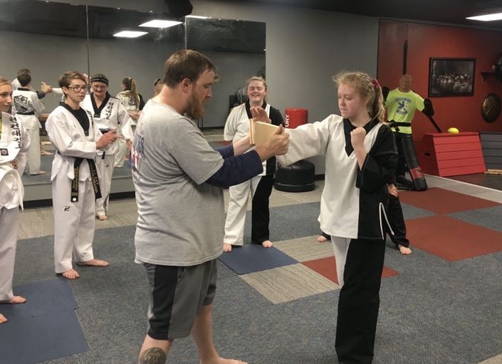 Senior Cheyenne Thomas  practices karate while her sister sophomore Christina Thomas watches.