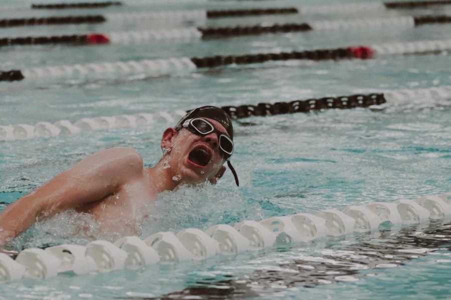 Ending the last event of his first swim meet, sophomore Nick Burt finishes off the last leg of the boys 400 yard freestyle relay. “I was nervous, but it was fun and really interesting to figure out how a swim meet works for the first time, Burt said.