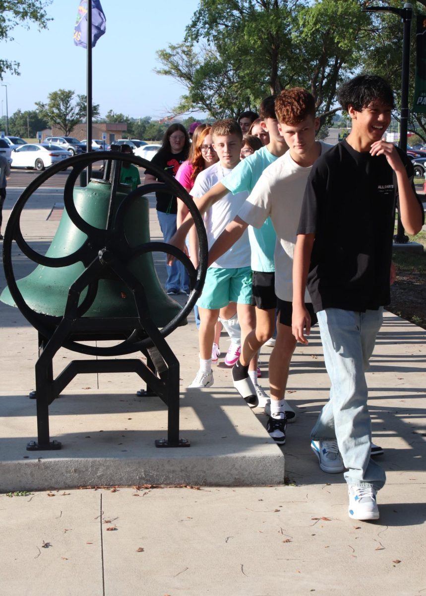 Student touches the bell.