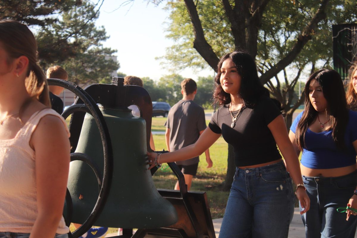 Student touches the bell