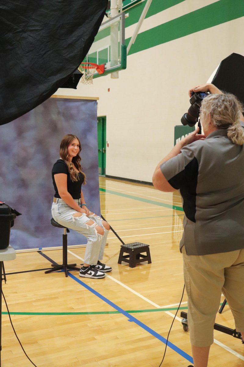 Student getting their photo taken. 