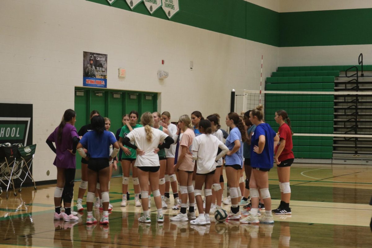 Volleyball players gather in a circle.