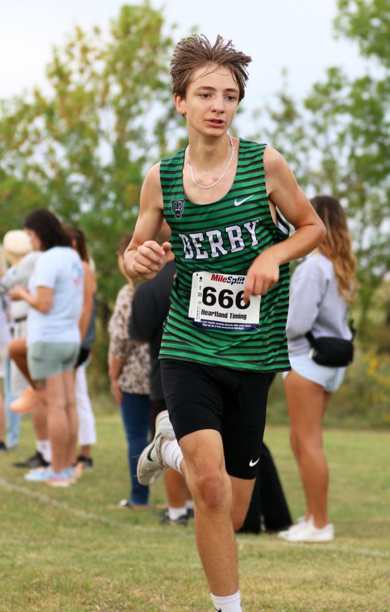 Freshman Ethan Smith pushes through the race to cross the finish line.