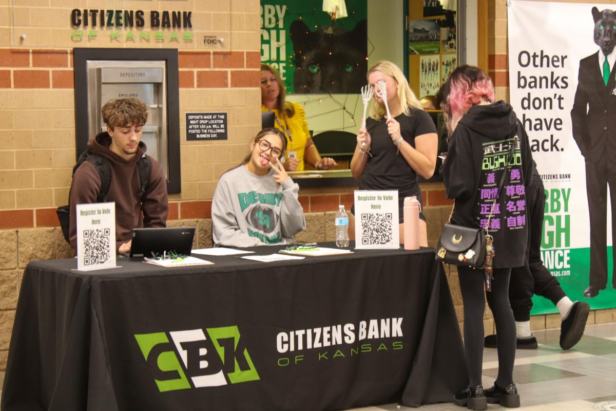 Students pose for a picture at the election sign up table.