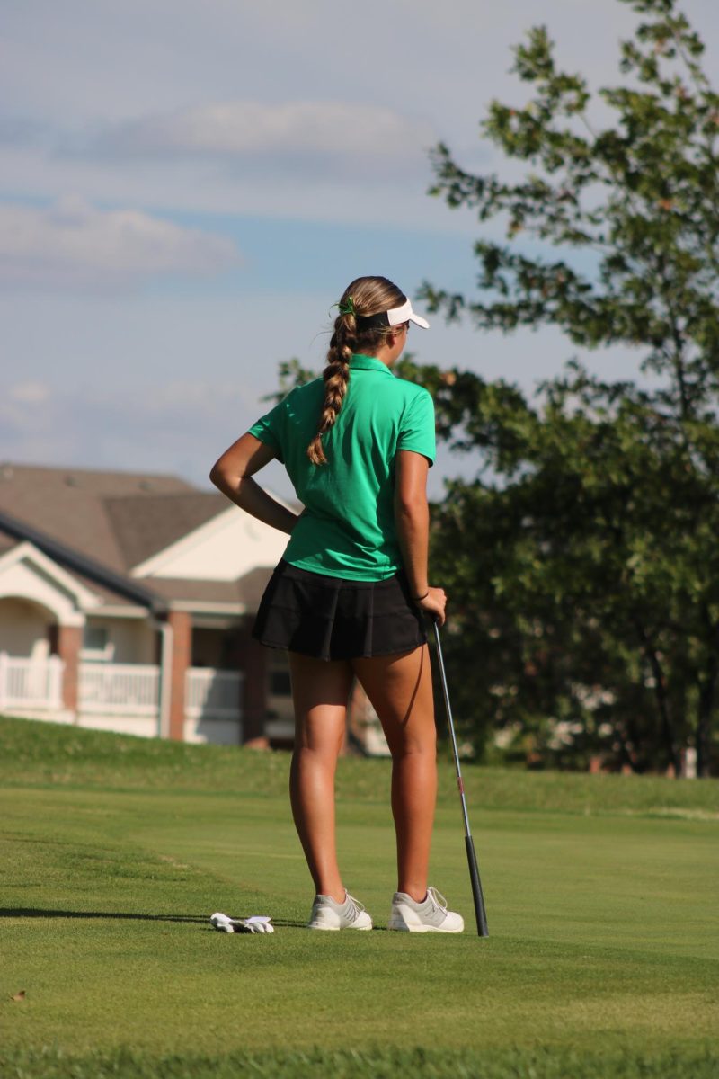 Girl golfer waits for her turn