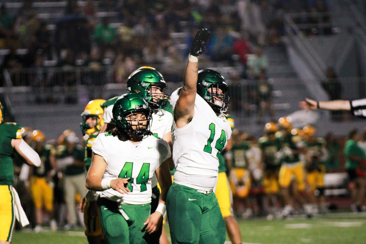 Senior Elijah Dixon salutes after tackle.