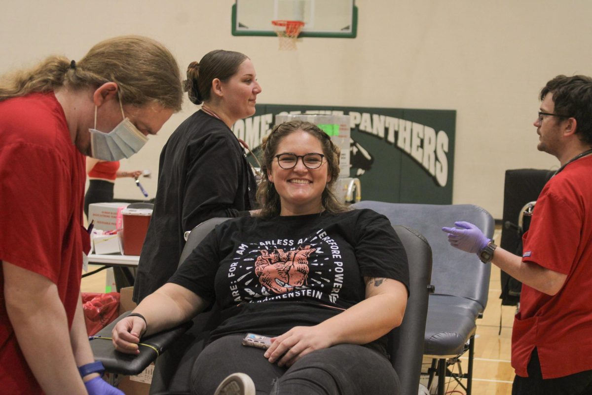 Teacher Abby Belt smiles while giving blood.