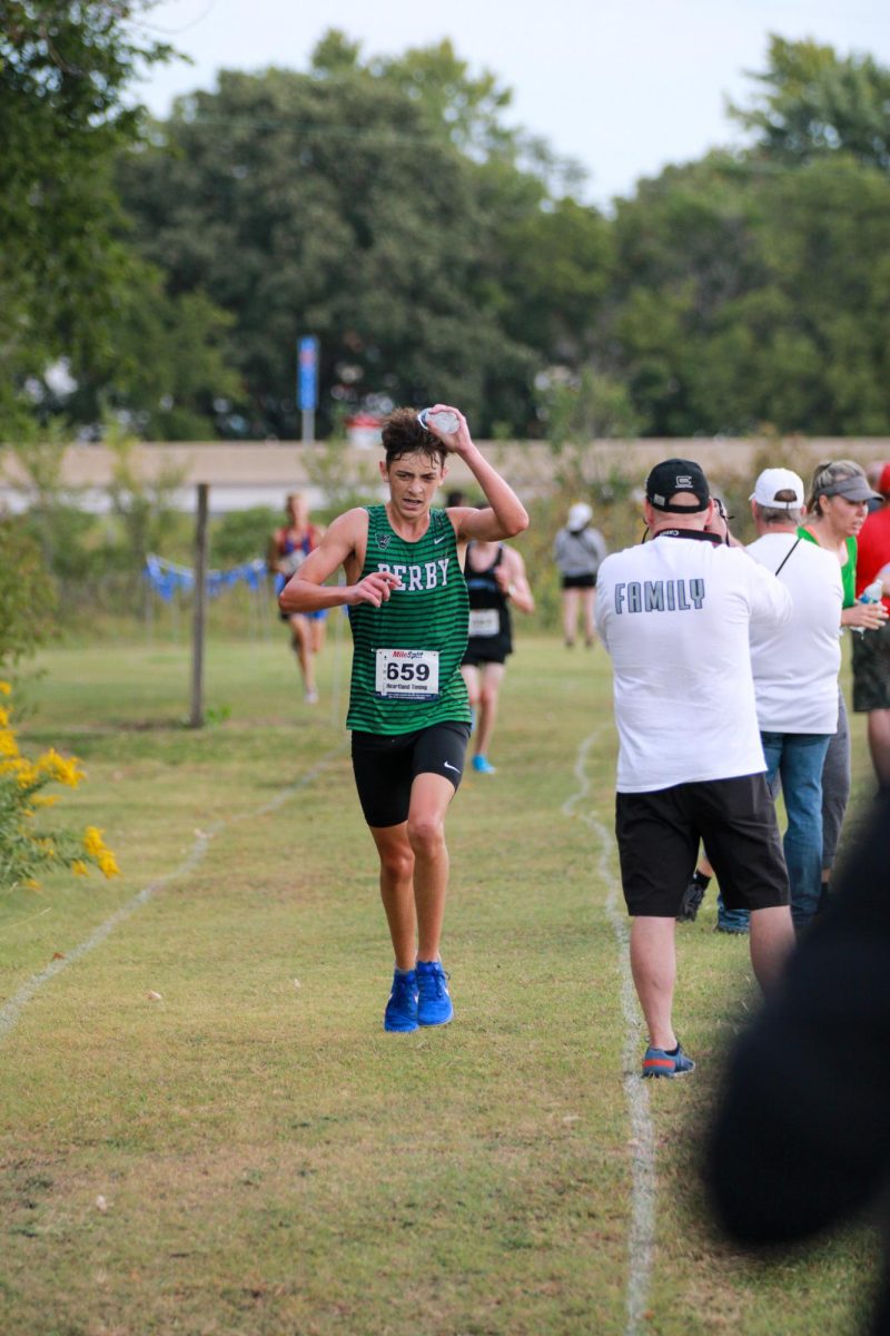 Senior Lucas Kreutzer is about to finish mile two and pours water on himself.