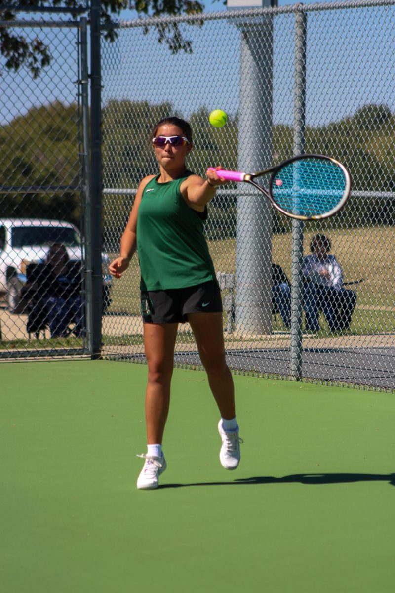 Player swings to hit the ball. 