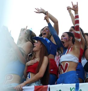 Seniors Loren Sweat, bottom left, Ava Boden, Madison Johnson, Addie Struble, top left, Carsen Carpenter and junior Braelyn Willams cheer after the national anthem.