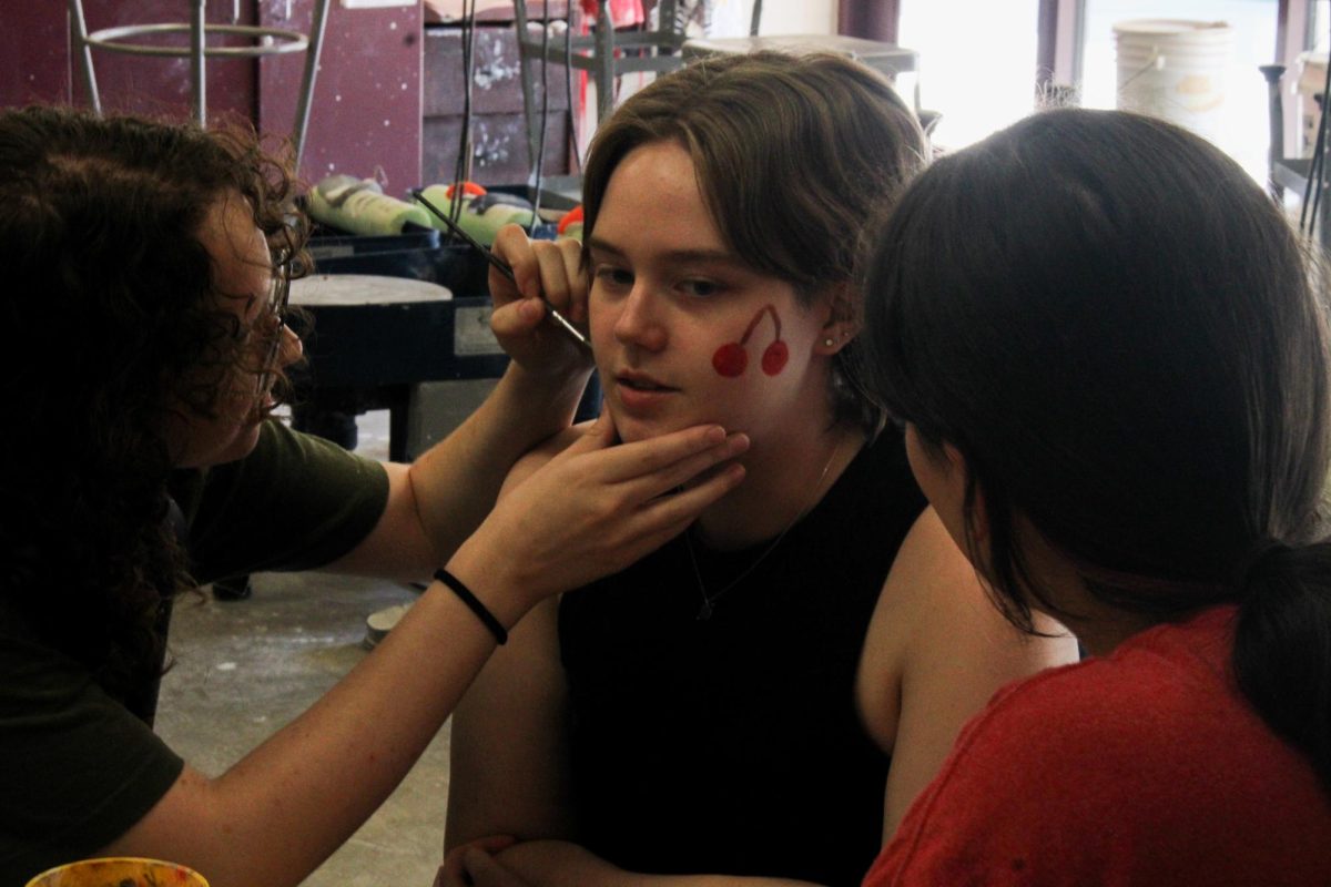 Students practice face painting.