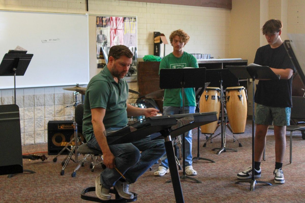 Tyler Morris conducting basses, junior Wyatt Goodin and sophomore Max Smeltzer.