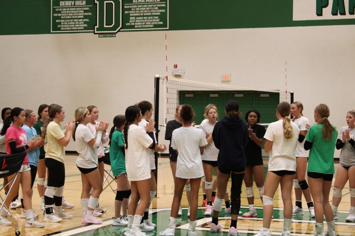 Volleyball team cheers during their warm up.