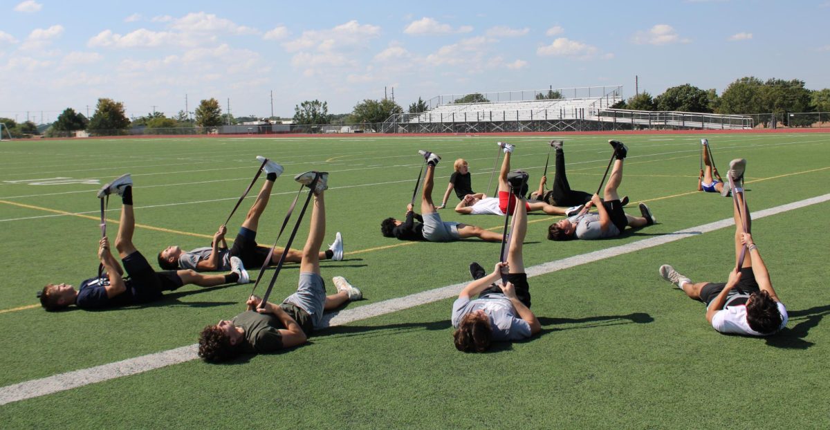 Students struggle to hold band stretch.