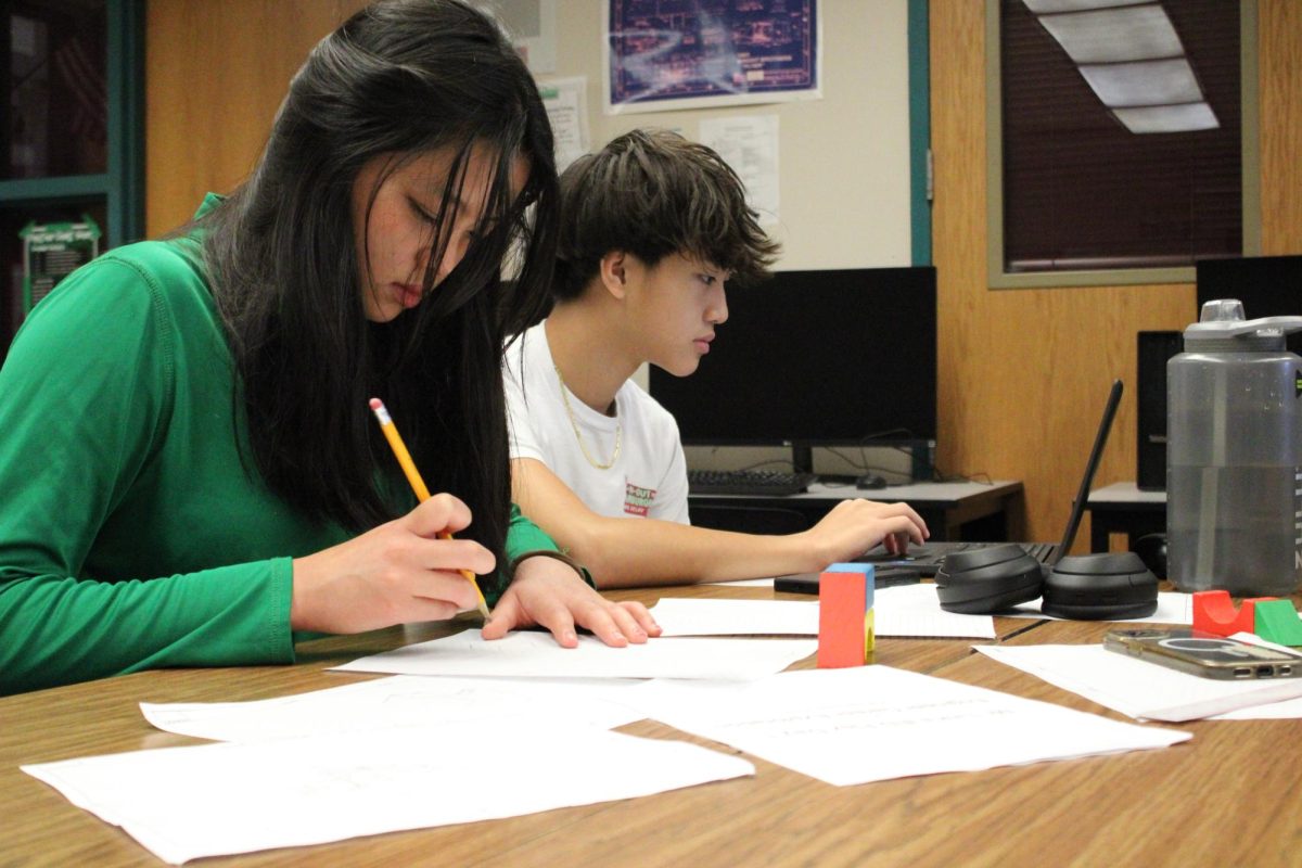 Two students work on their sketches.