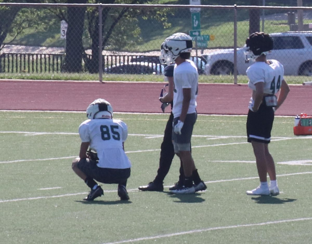 Football players get ready to practice.