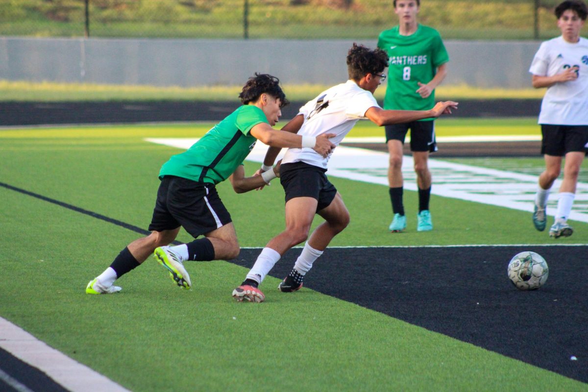 Senior Alex Pham shoves opponent to get to the ball. 