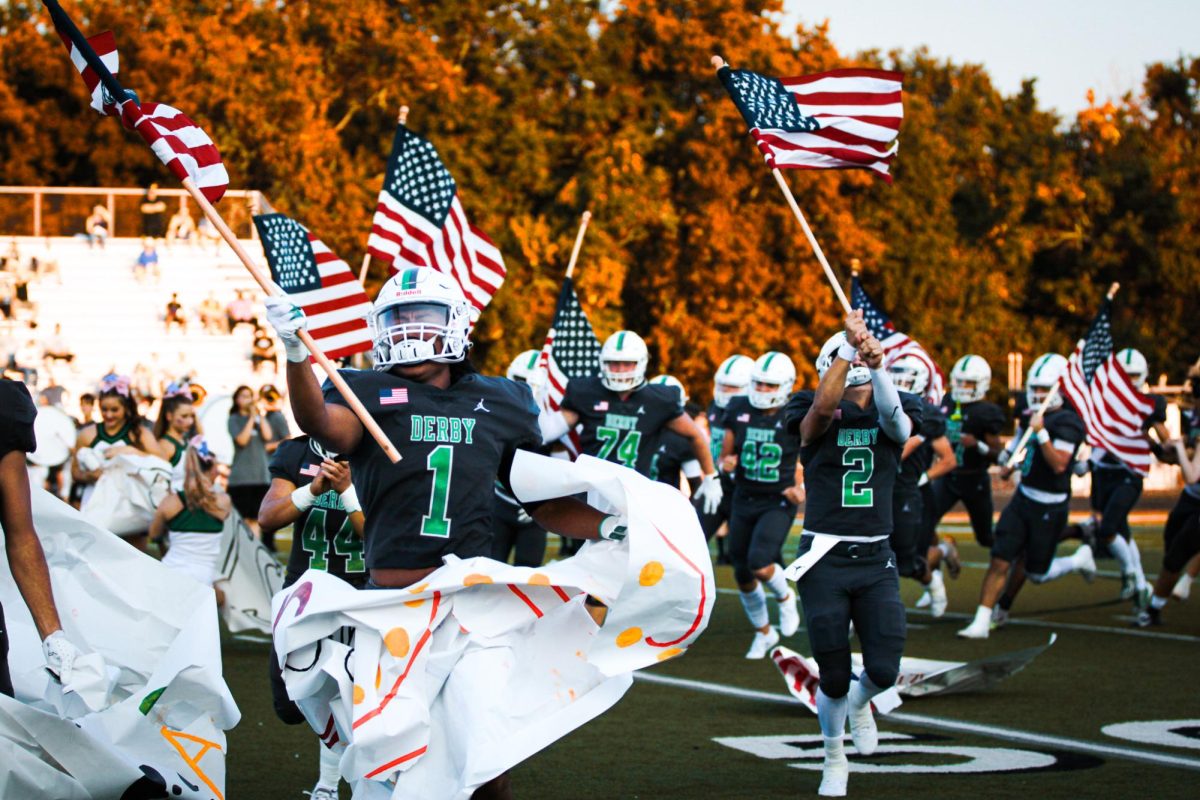 Football player runs with flags.