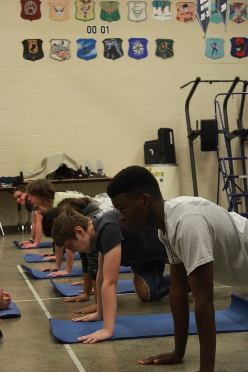 Students do push ups.