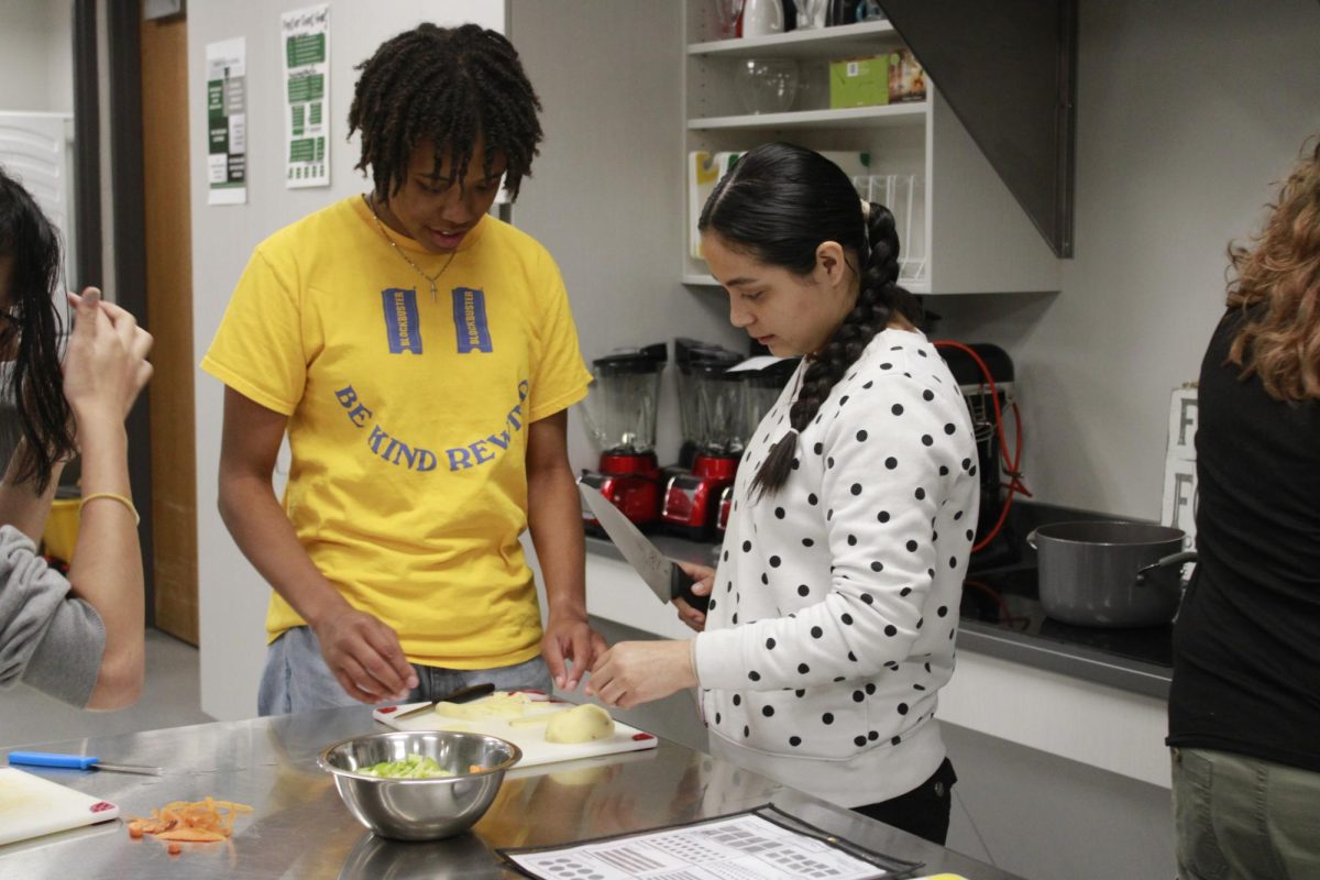 Students chop veggies for the soup.