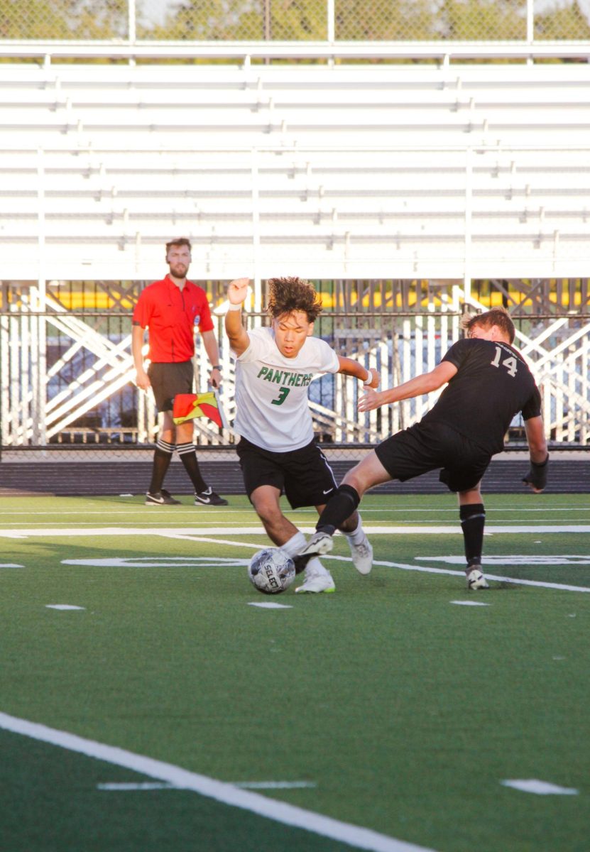 Senior Alex Pham dribbles the ball in the midfield.