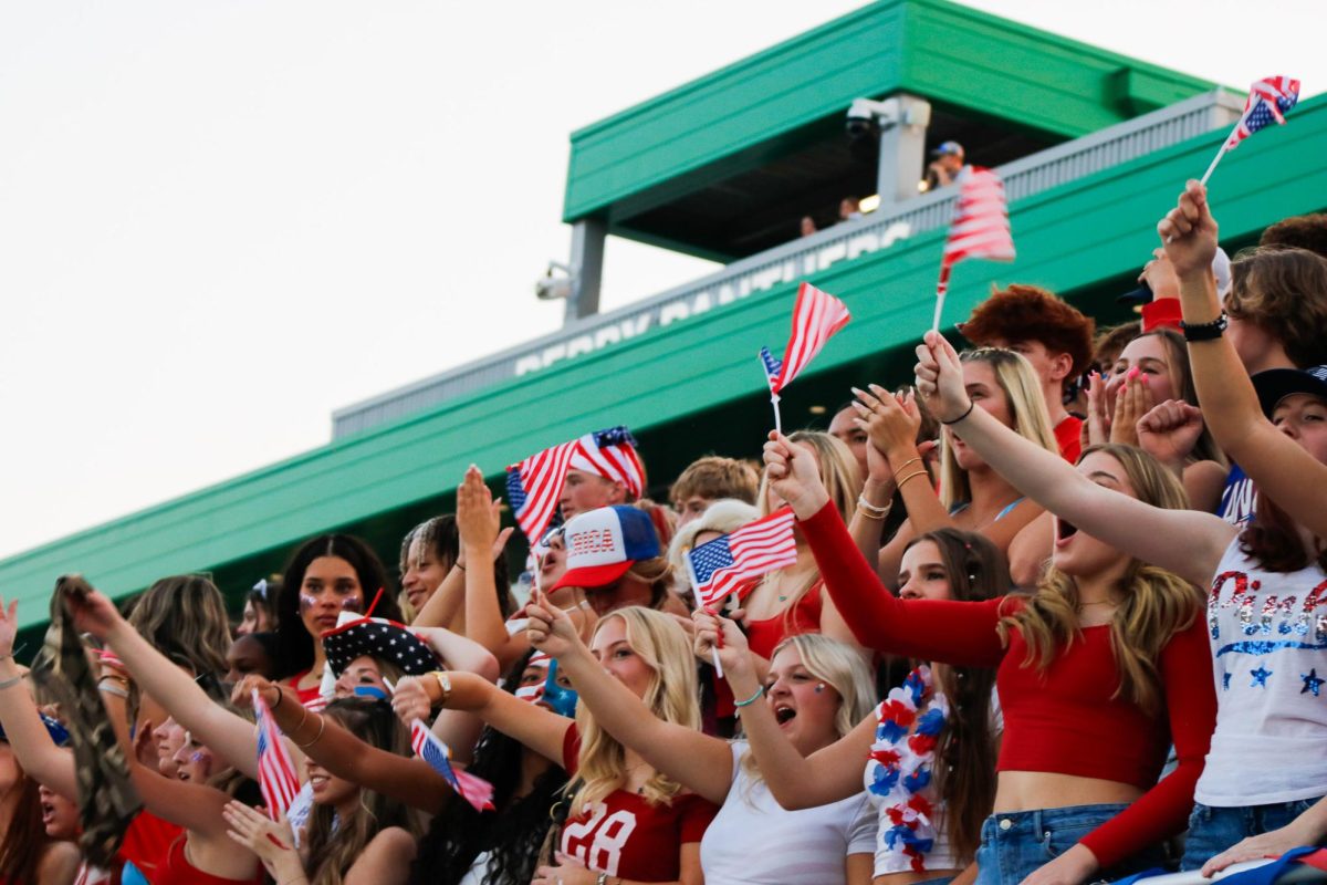 Student section waves flags.