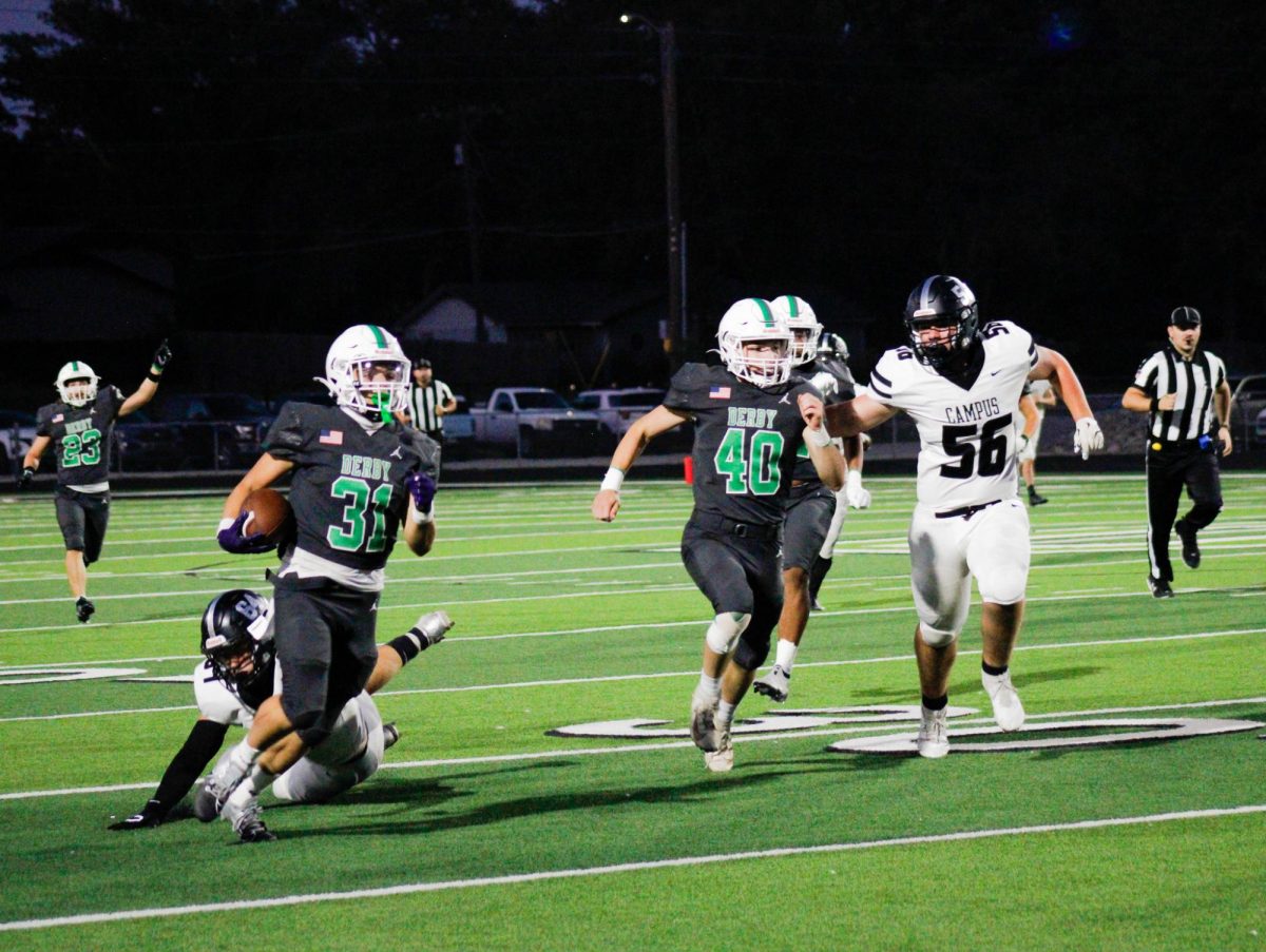 On the left, junior Isaac Nikolas runs past the Campus defense alongside his teammate, (right) junior Cooper Williams. 