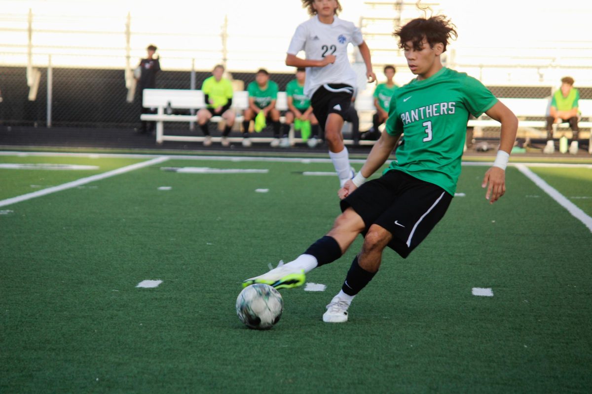 Senior Alex Pham kicks the ball. 