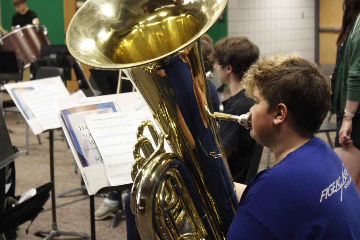 Student practices on his tuba.
