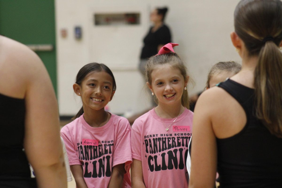 Two kids talk to pantherettes. 