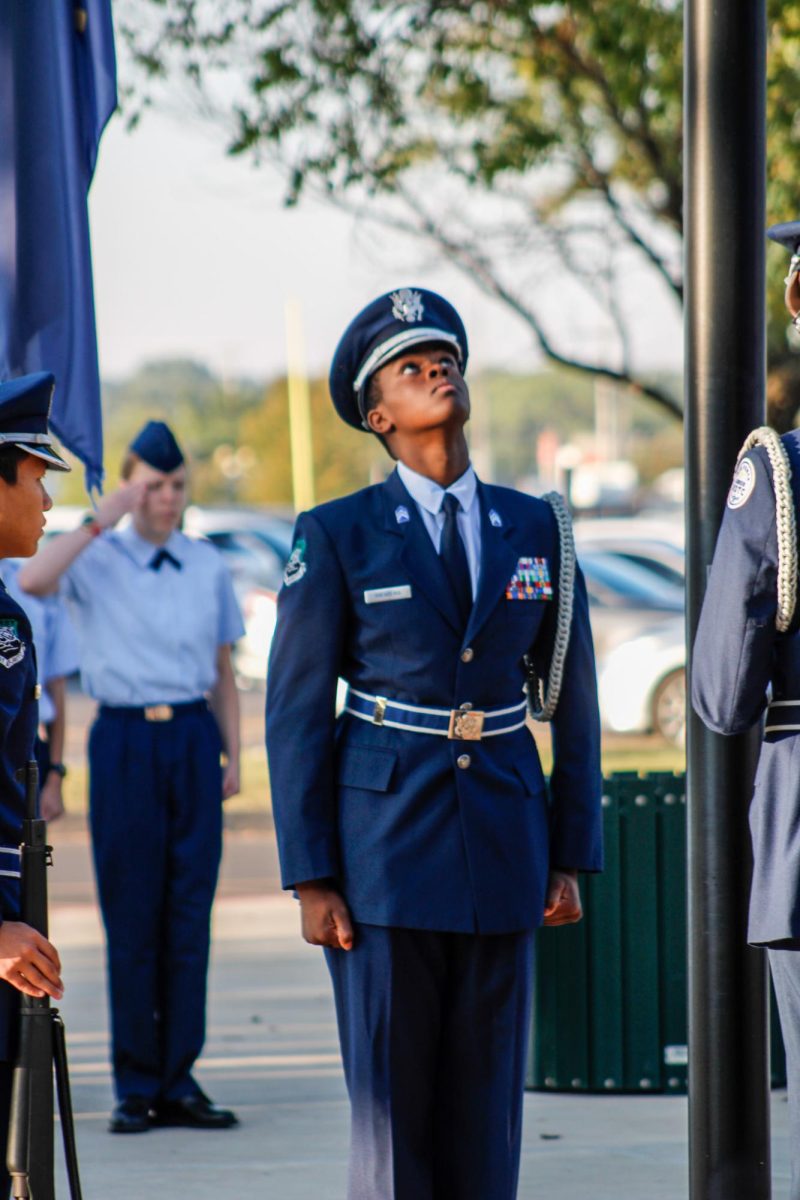 Junior Jerome Mwarema looks up at flag.