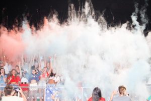 Student section throwing powder into the air to show their spirit.