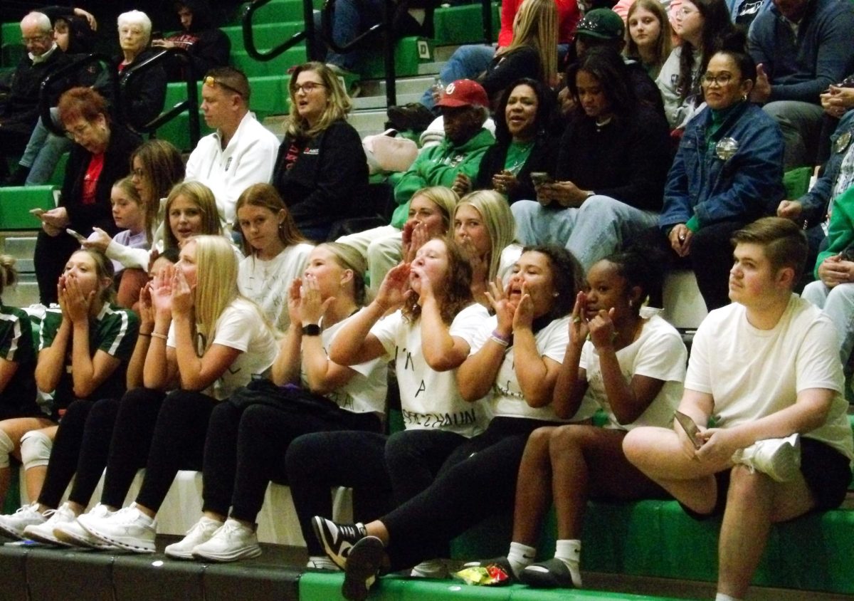 The student section yells to cheer on the team.