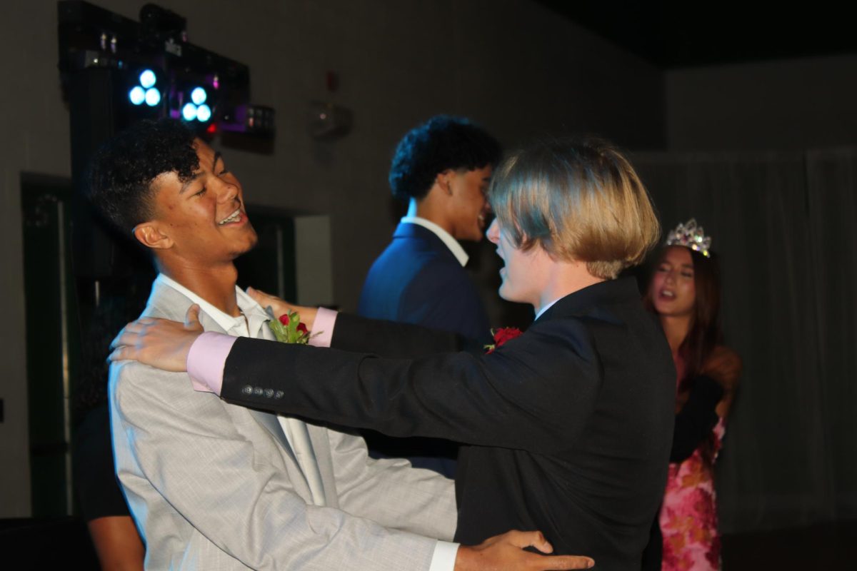 Homecoming court candidates Caleb Rogers (left) and Jared Hays (right) dance and sing together after they are announced.