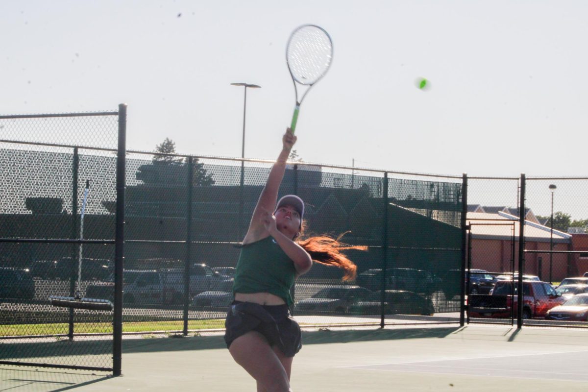 Senior Isabella Nikolova hitting the ball.