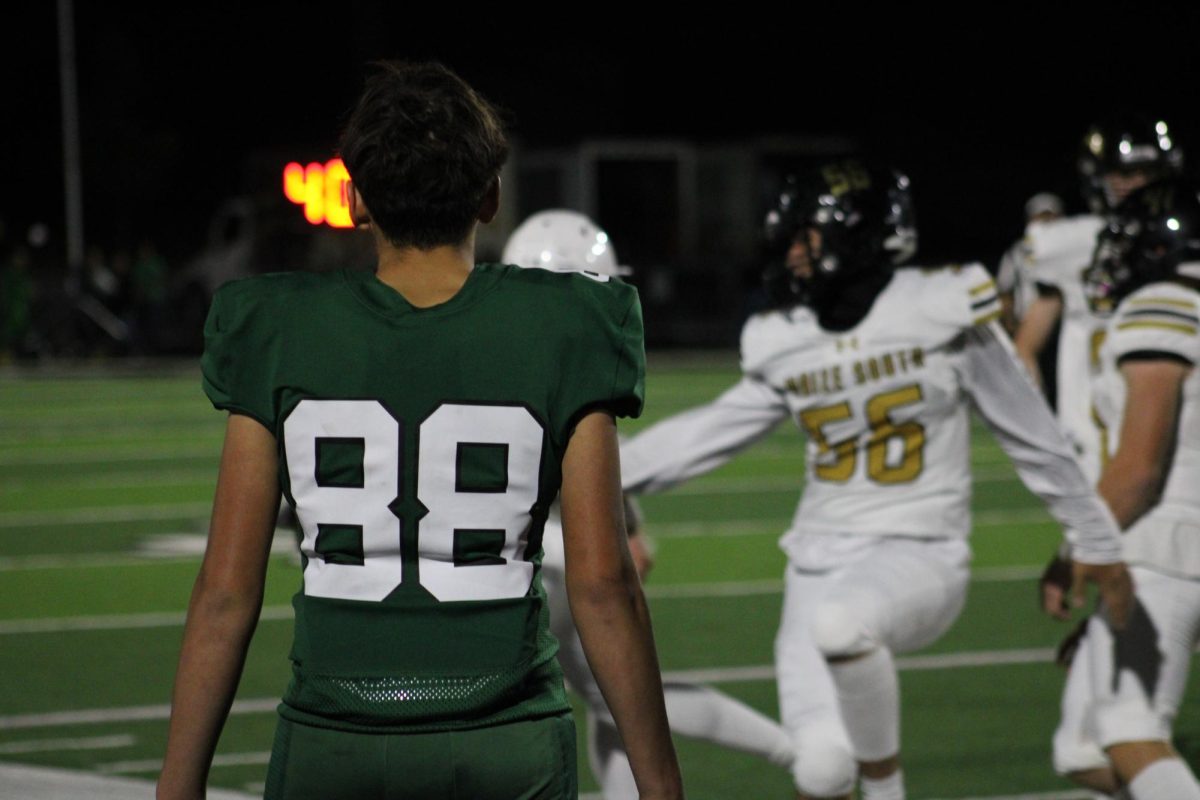 Player watches the game from the sideline