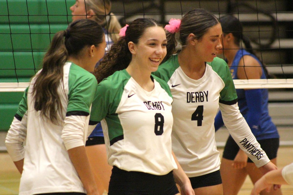 Seniors Lily waters(Left) and Carsen Carpenter(Right) congratulate Lillian Like(Middle) on a play. 