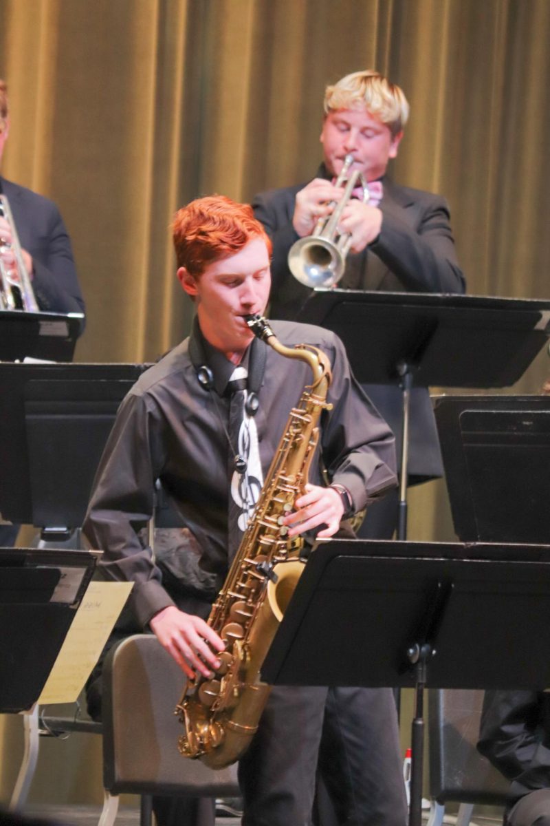 Student plays saxophone during his solo.