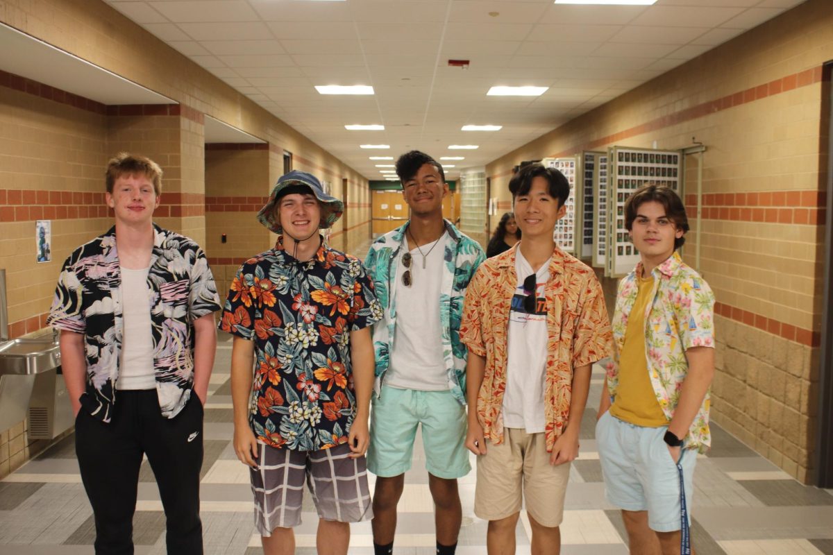 Seniors Kendall Chance, Jared Hays, Caleb Rogers, Justin Tang and Taylor Broberg smile for a picture in the hall. 