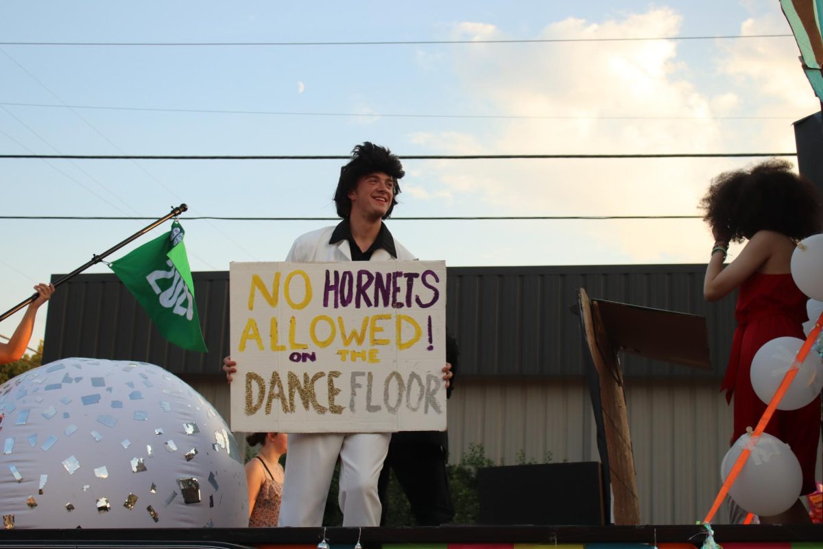 Wyatt Goodin dancing for stucco class float