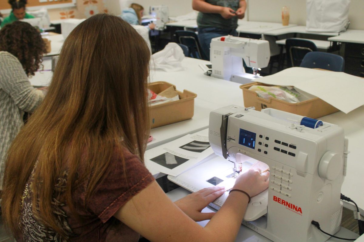 Student sews on the sewing machine