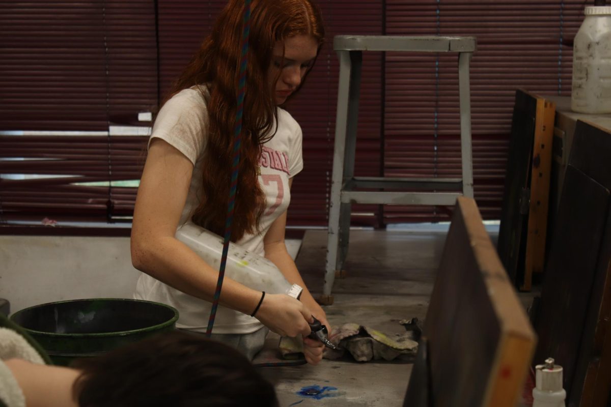 Student refills her airbrush.